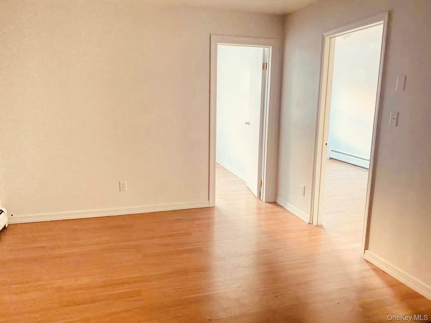 41-08 111th Street Queens, NY 11368 - Photo 7 of 9 a view of an empty room and wooden floor