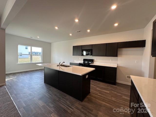 6128 Busch Way Midland, NC 28107 - Photo 11 of 26 a kitchen with a cabinets and wooden floor
