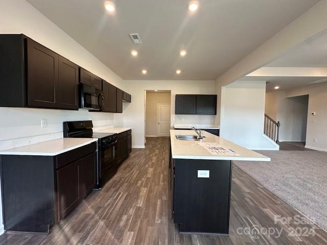 6128 Busch Way Midland, NC 28107 - Photo 12 of 26 a kitchen with kitchen island a sink dishwasher stove and oven with wooden floor