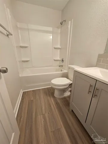a bathroom with a sink a toilet a mirror and shower