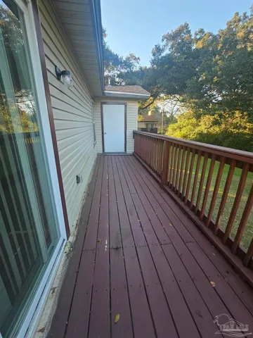 a view of balcony with wooden floor