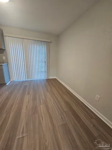 a view of a room with wooden floor