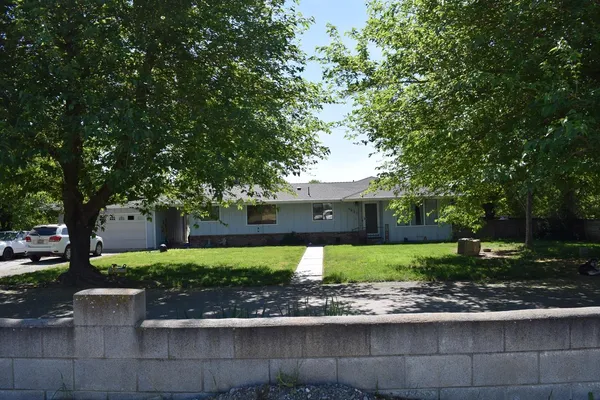 a front view of a house with a yard and a garage