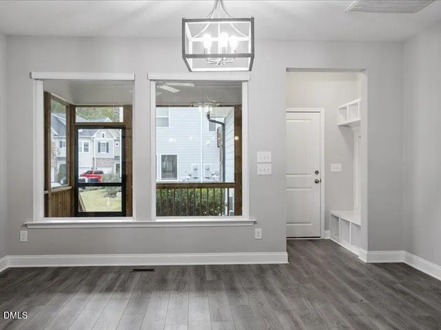 a view of staircase with wooden floor and white walls