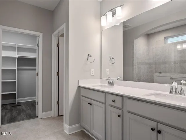 a bathroom with a shower and a sink