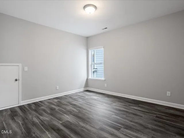 a view of wooden floor and windows in a room
