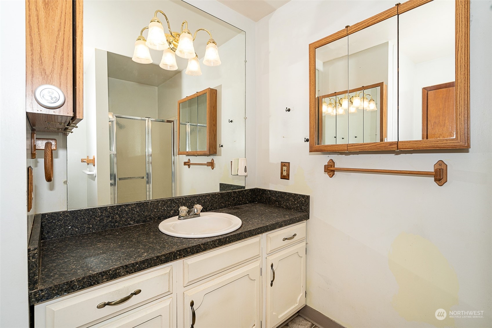 728 Rhoades Road Winlock, WA 98596 - Photo 12 of 40 a bathroom with a granite countertop sink and a mirror