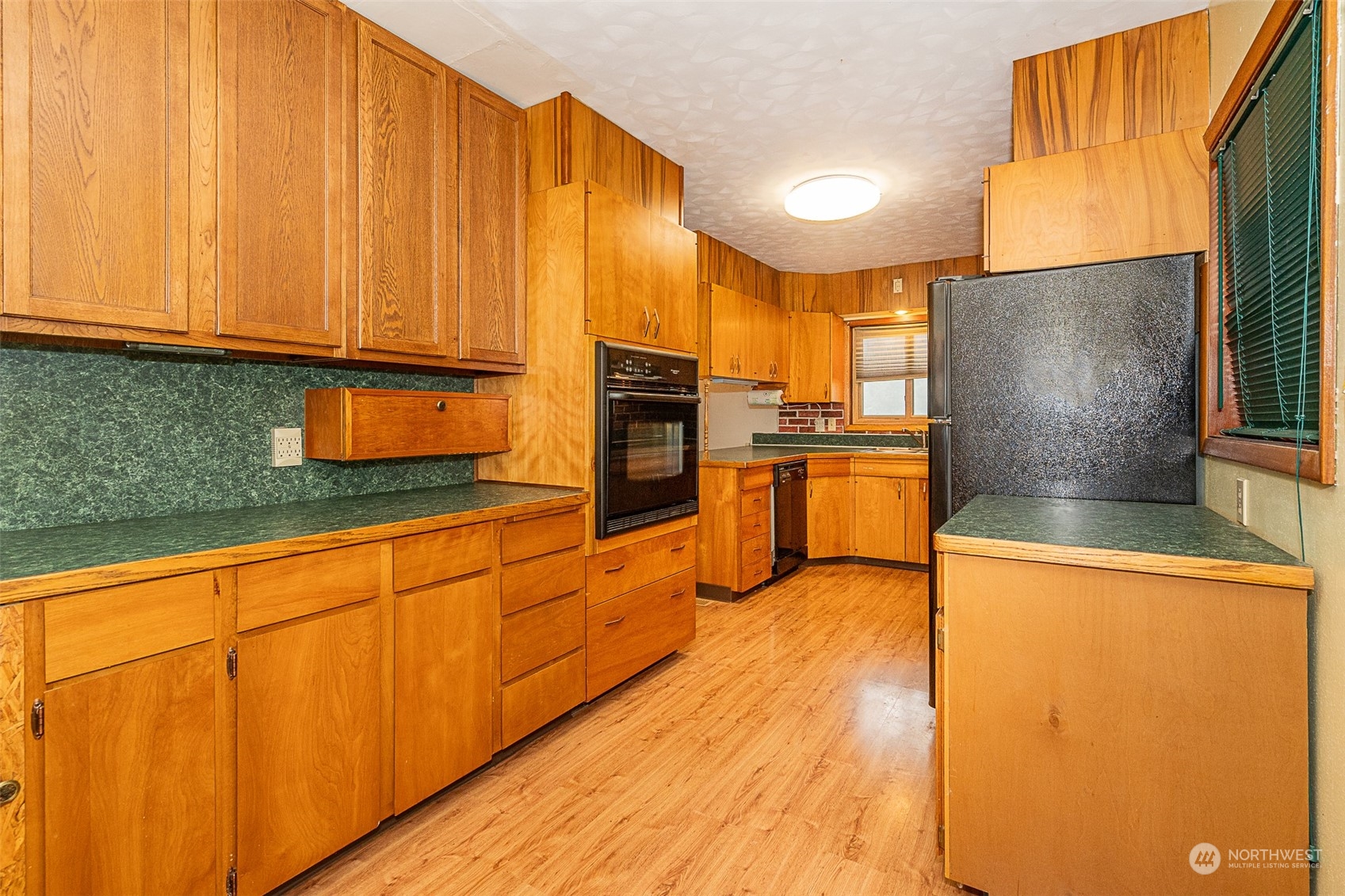 728 Rhoades Road Winlock, WA 98596 - Photo 19 of 40 a kitchen with stainless steel appliances granite countertop a refrigerator a stove and white cabinets with wooden floor