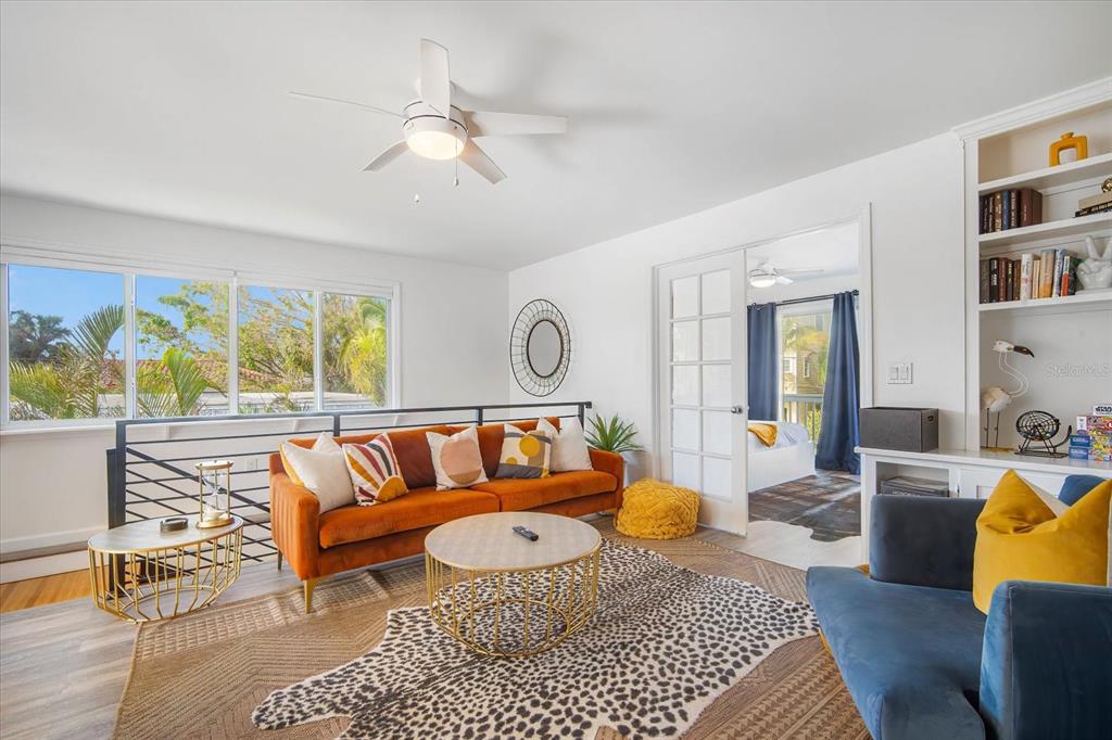 203 72nd Street Holmes Beach, FL 34217 - Photo 18 of 75 a living room with furniture a rug and a large window