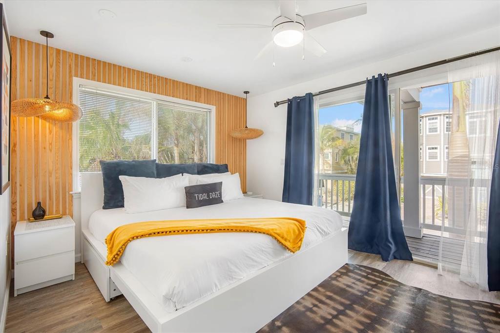 203 72nd Street Holmes Beach, FL 34217 - Photo 19 of 75 a bed sitting in a bedroom next to a window