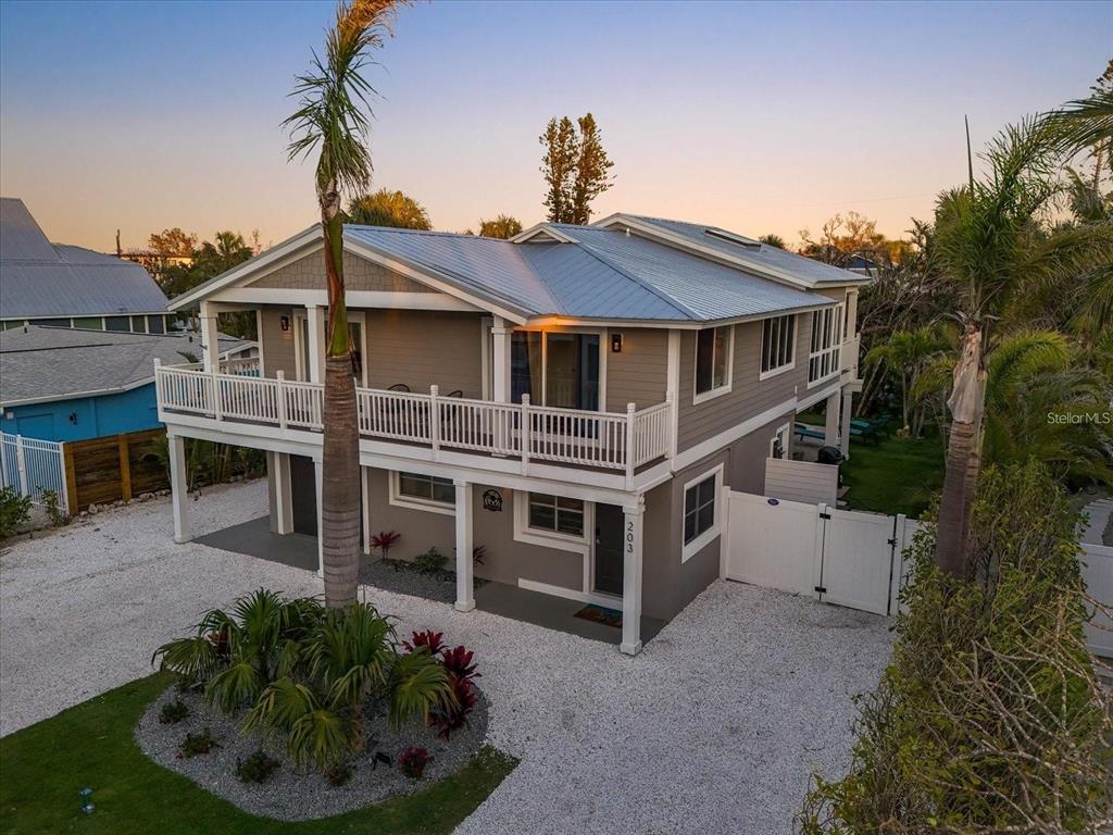 203 72nd Street Holmes Beach, FL 34217 - Photo 2 of 75 a front view of a house with a yard