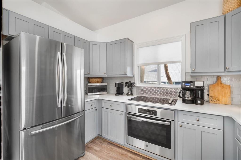 203 72nd Street Holmes Beach, FL 34217 - Photo 35 of 75 a kitchen with a refrigerator sink and cabinets