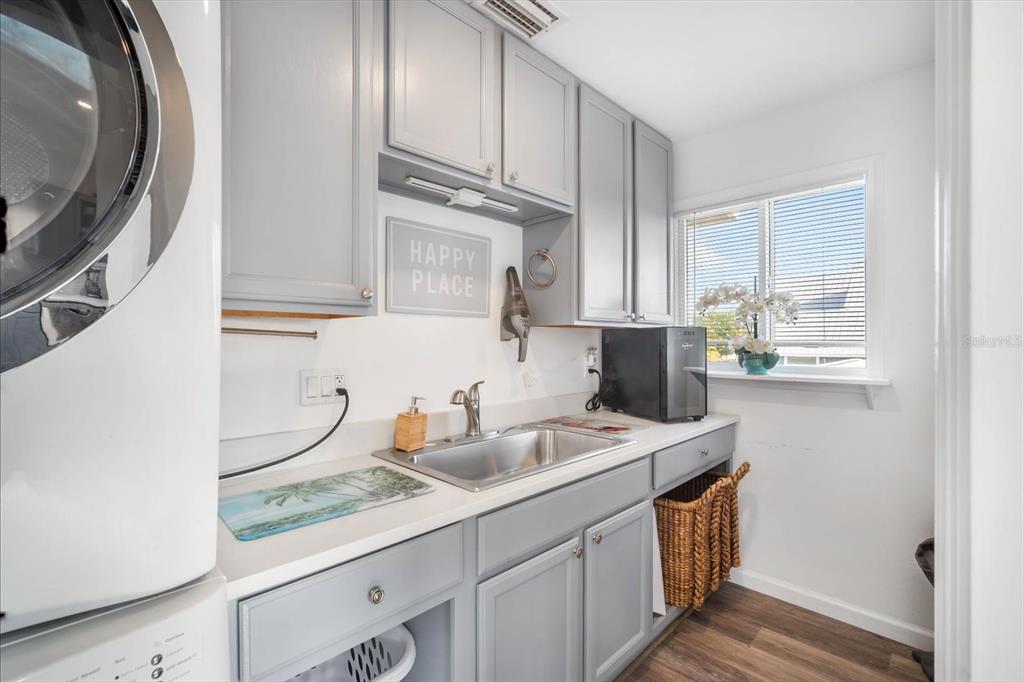 203 72nd Street Holmes Beach, FL 34217 - Photo 40 of 75 a kitchen with stainless steel appliances a sink and a stove top oven