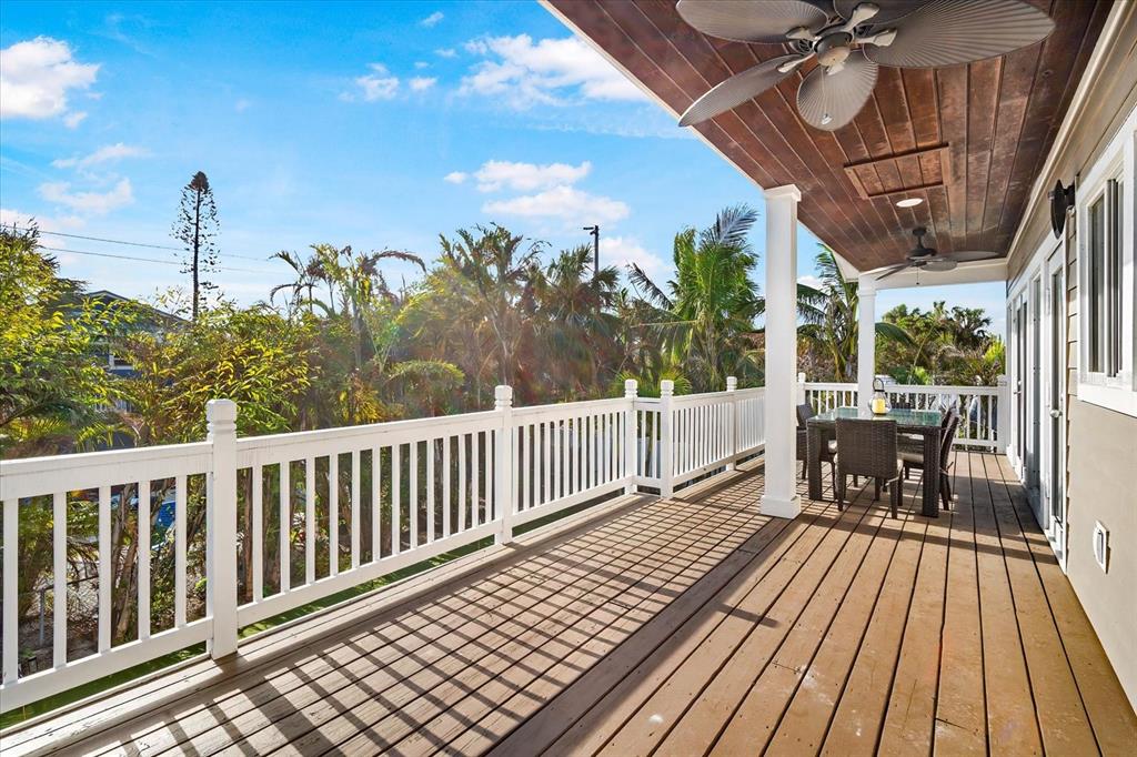 203 72nd Street Holmes Beach, FL 34217 - Photo 42 of 75 a view of balcony with wooden floor and outdoor seating