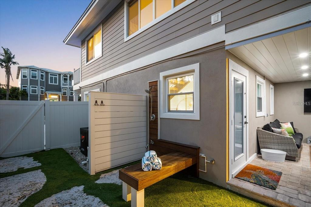 203 72nd Street Holmes Beach, FL 34217 - Photo 48 of 75 a backyard of a house with seating space