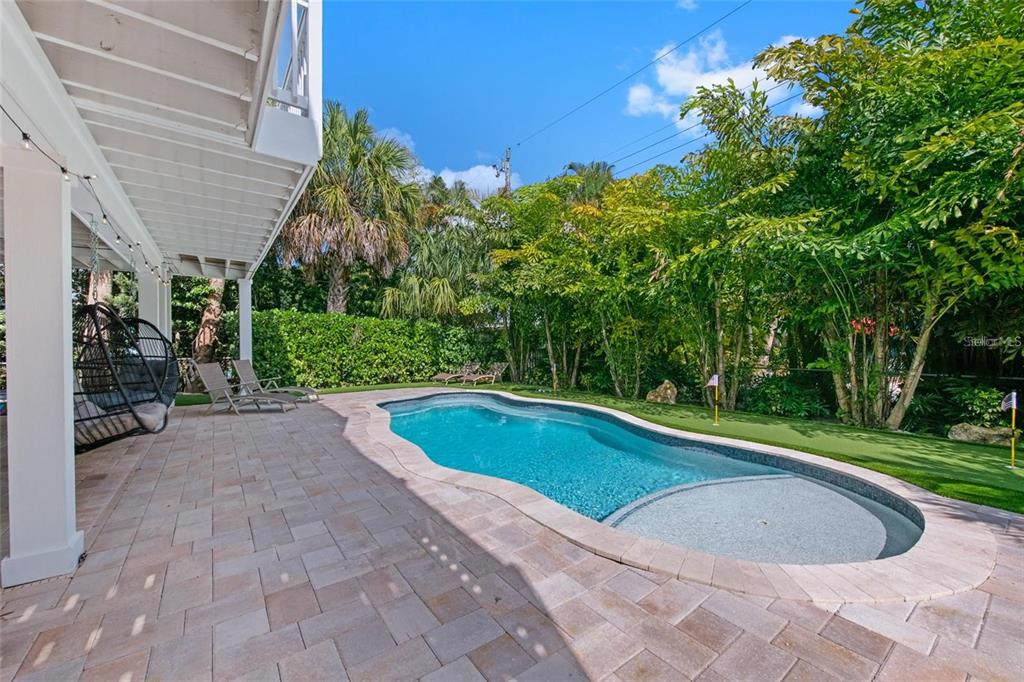203 72nd Street Holmes Beach, FL 34217 - Photo 53 of 75 a view of backyard with swimming pool and outdoor seating