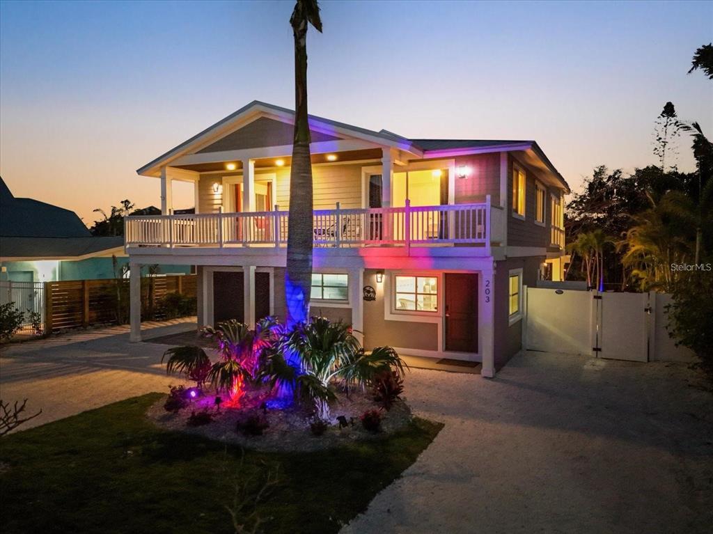 203 72nd Street Holmes Beach, FL 34217 - Photo 58 of 75 a front view of a house with yard