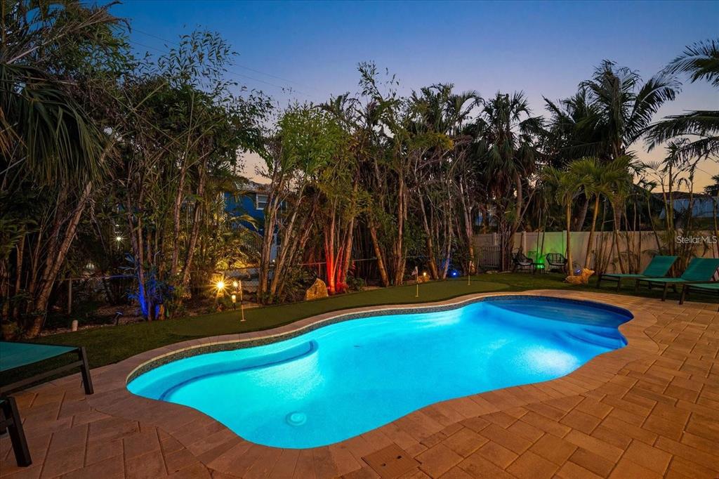 203 72nd Street Holmes Beach, FL 34217 - Photo 62 of 75 a view of a swimming pool with an outdoor space and seating area