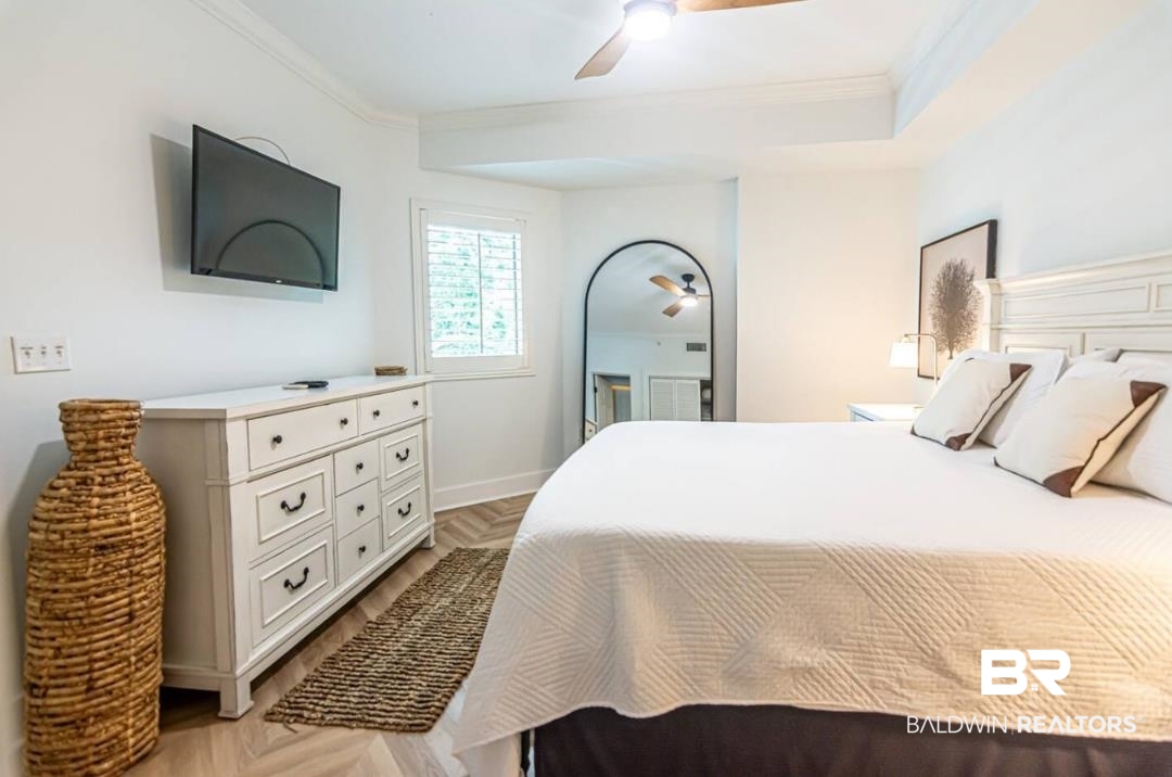 27800 Canal Road, Unit 212 Orange Beach, AL 36561 - Photo 33 of 43 Bedroom featuring ornamental molding and a ceiling fan