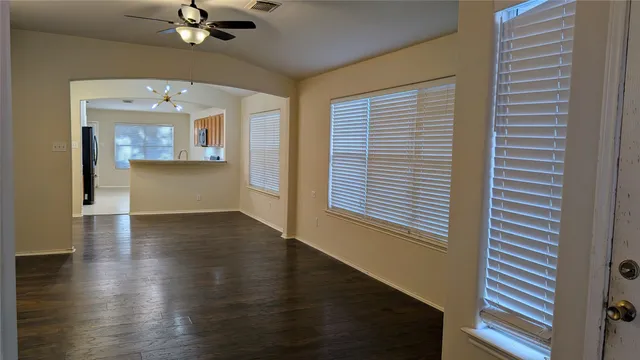 wooden floor in an empty room with a window