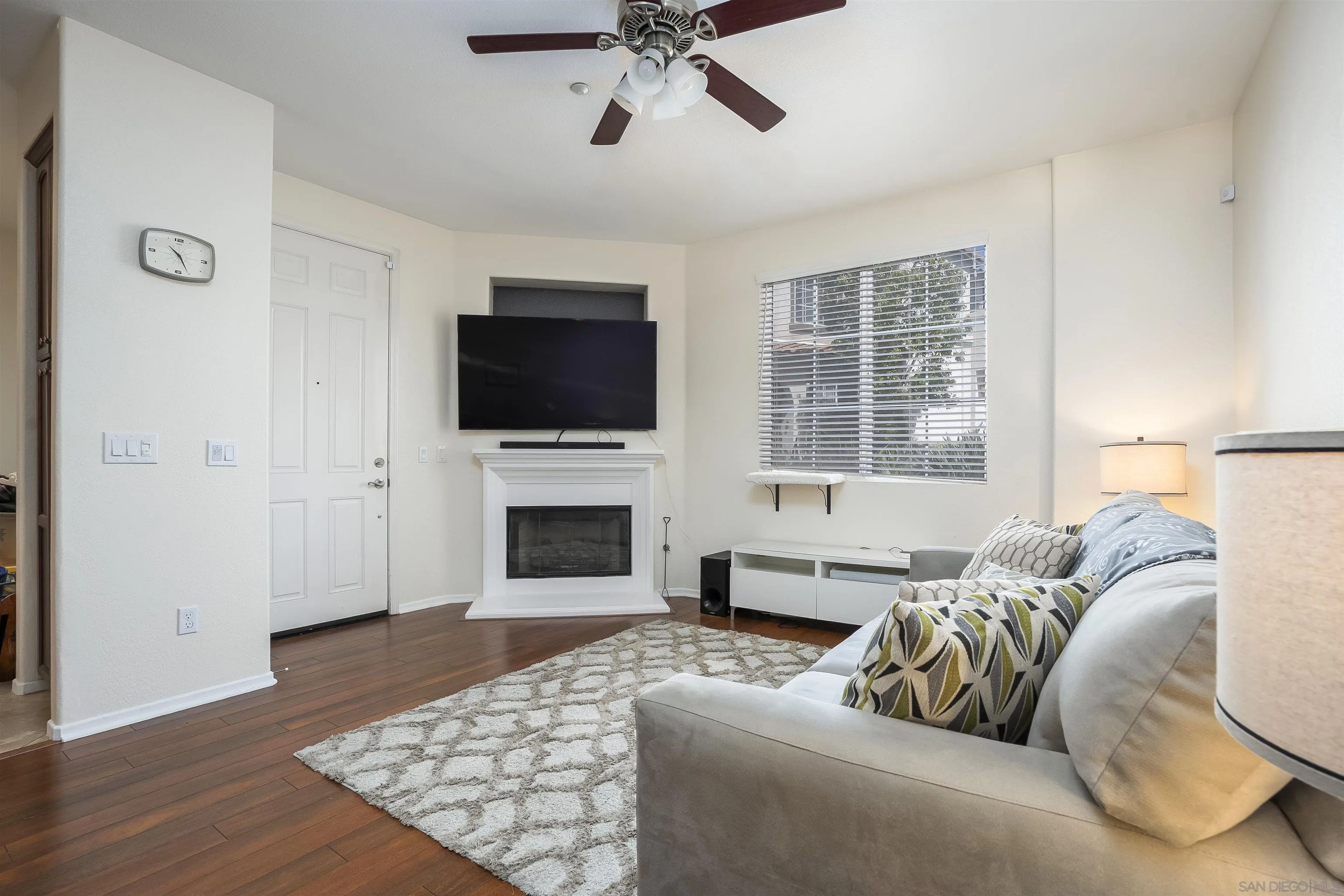 289 Reef Point Way, Unit 3 Oceanside, CA 92058 - Photo 4 of 23 a living room with furniture and a flat screen tv