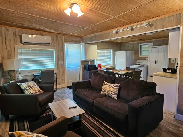 a living room with furniture and a chandelier