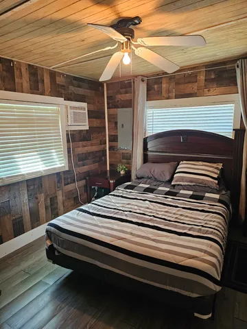 a bed sitting in a bedroom next to a window