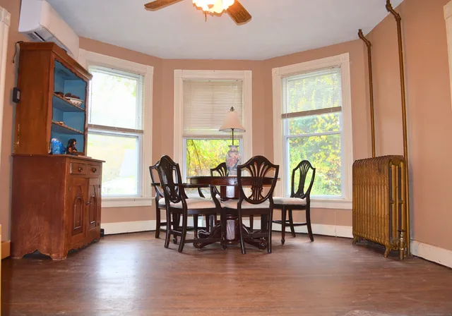a view of a dining room with furniture and window