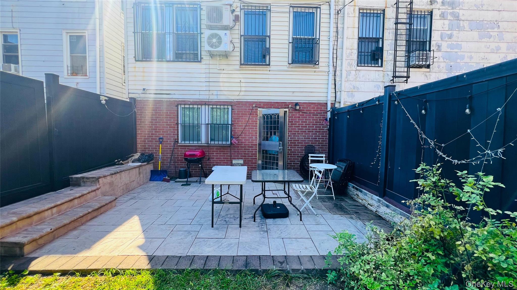 64-09 Woodside Avenue, Unit 2 FAMILY FRAME Queens, NY 11377 - Photo 15 of 17 a view of a house with patio