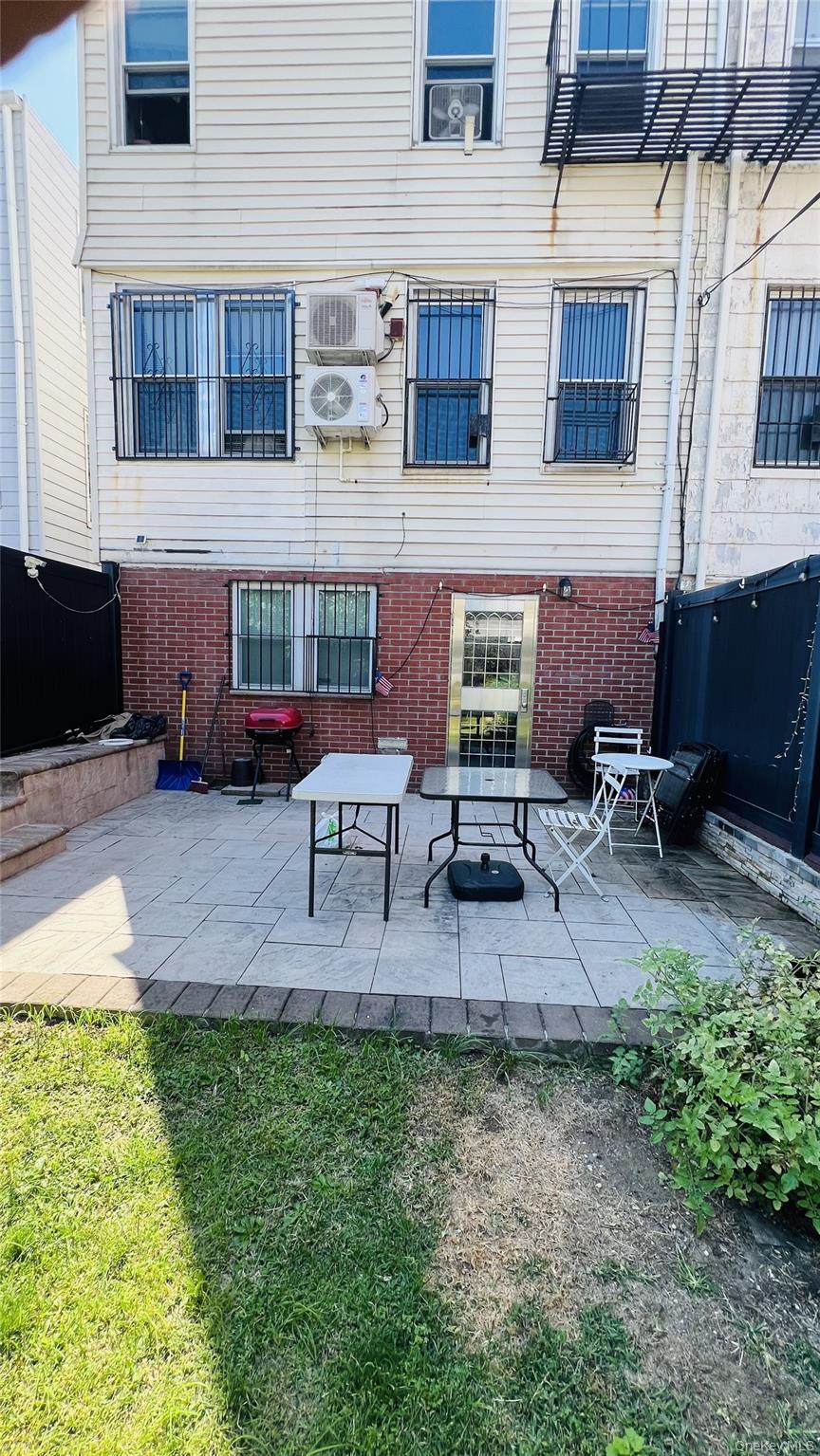 64-09 Woodside Avenue, Unit 2 FAMILY FRAME Queens, NY 11377 - Photo 17 of 17 a view of backyard with seating space and barbeque oven