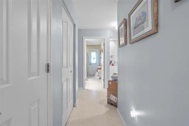 a view of a hallway with bathroom and shower