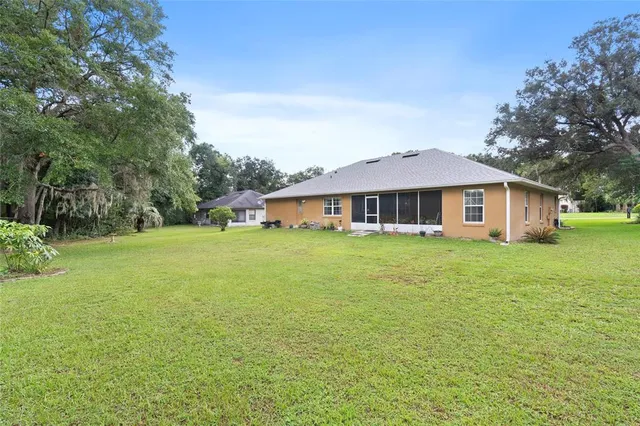 a front view of a house with yard and green space