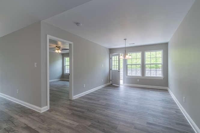 700 Spring Park Road Knoxville, TN 37914 - Photo 2 of 25 an empty room with wooden floor and windows