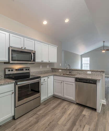 700 Spring Park Road Knoxville, TN 37914 - Photo 4 of 25 a kitchen with granite countertop a stove top oven a sink and dishwasher a oven with wooden floor