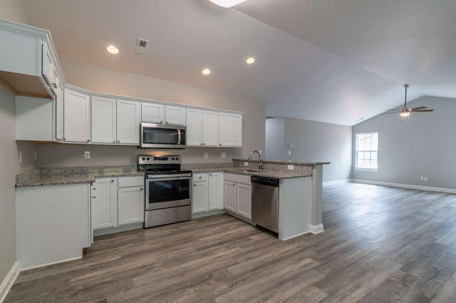 700 Spring Park Road Knoxville, TN 37914 - Photo 5 of 25 a kitchen with granite countertop a stove top oven and cabinets
