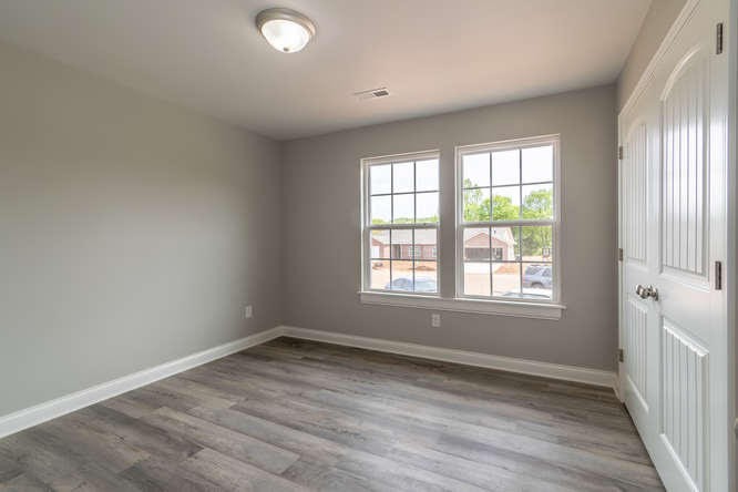 700 Spring Park Road Knoxville, TN 37914 - Photo 8 of 25 an empty room with wooden floor and windows