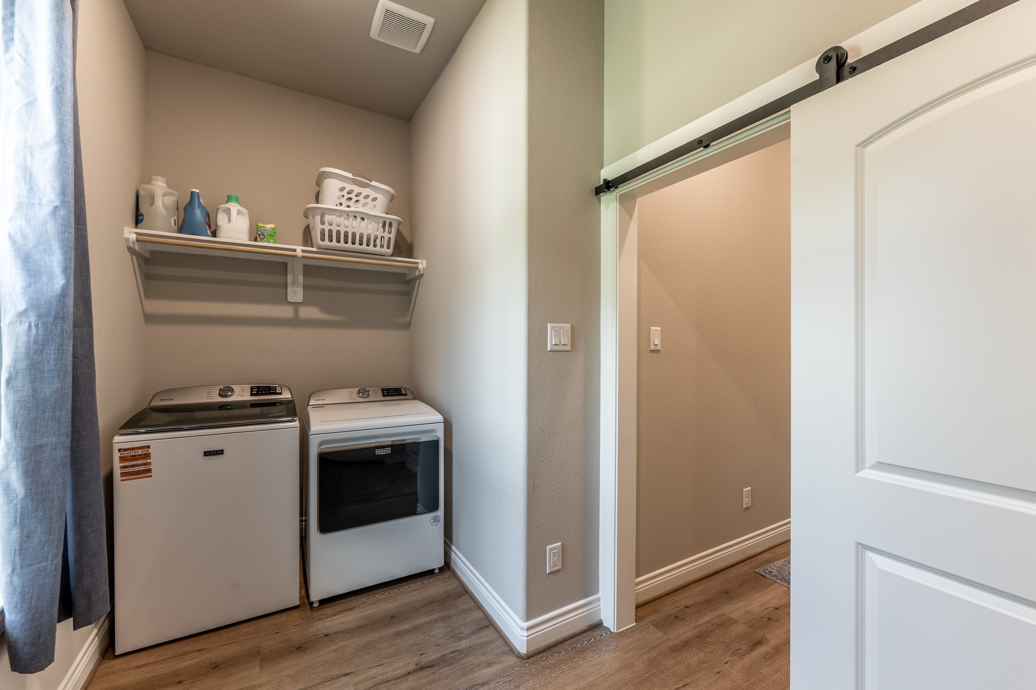 111 Eagle Run Road Willis, TX 77378 - Photo 27 of 44 Convenient barn door encloses the laundry area, with an additional half bath nearby.