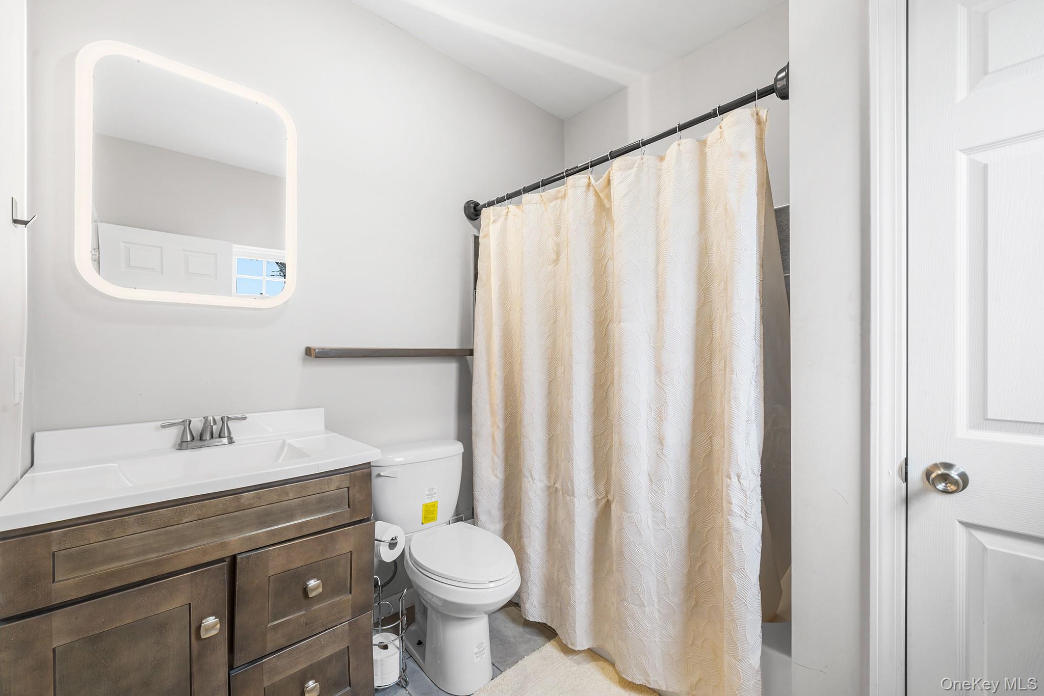 5 Oak Ridge Road Middletown, NY 10940 - Photo 16 of 24 a bathroom with a sink a toilet and shower curtain