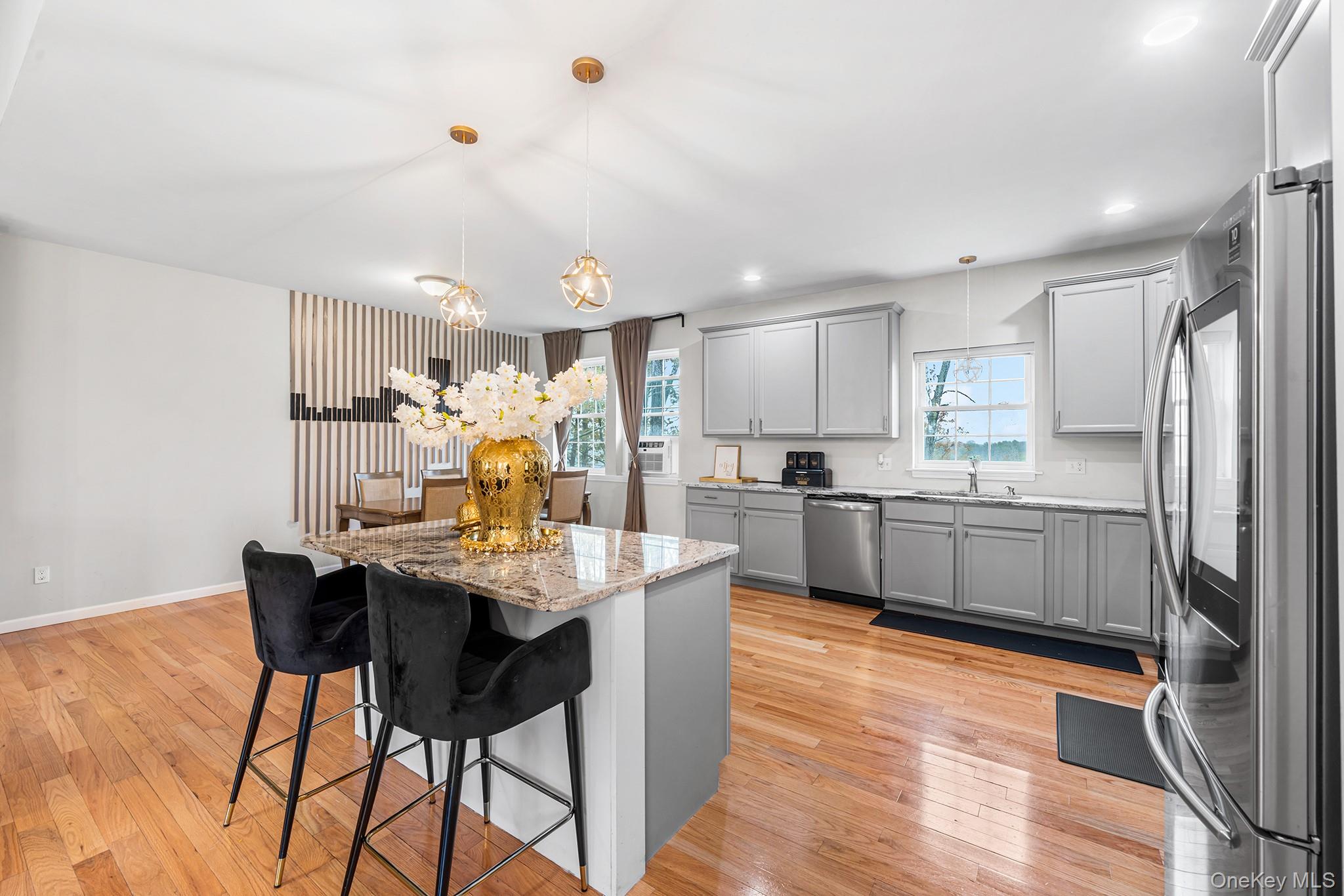 5 Oak Ridge Road Middletown, NY 10940 - Photo 3 of 24 a kitchen with stainless steel appliances granite countertop a table chairs and a refrigerator