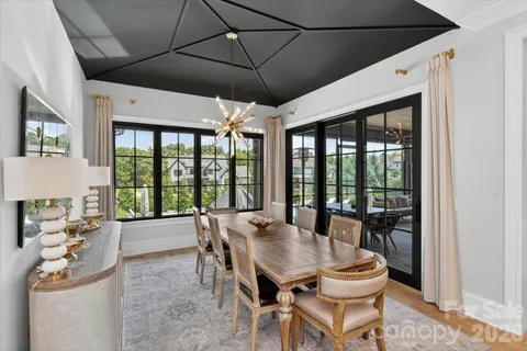a view of a dining room with furniture large windows and wooden floor