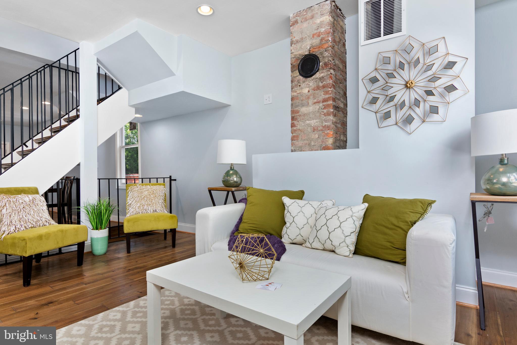 3738 Falls Road Baltimore, MD 21211 - Photo 3 of 39 Living room with exposed brick chimney