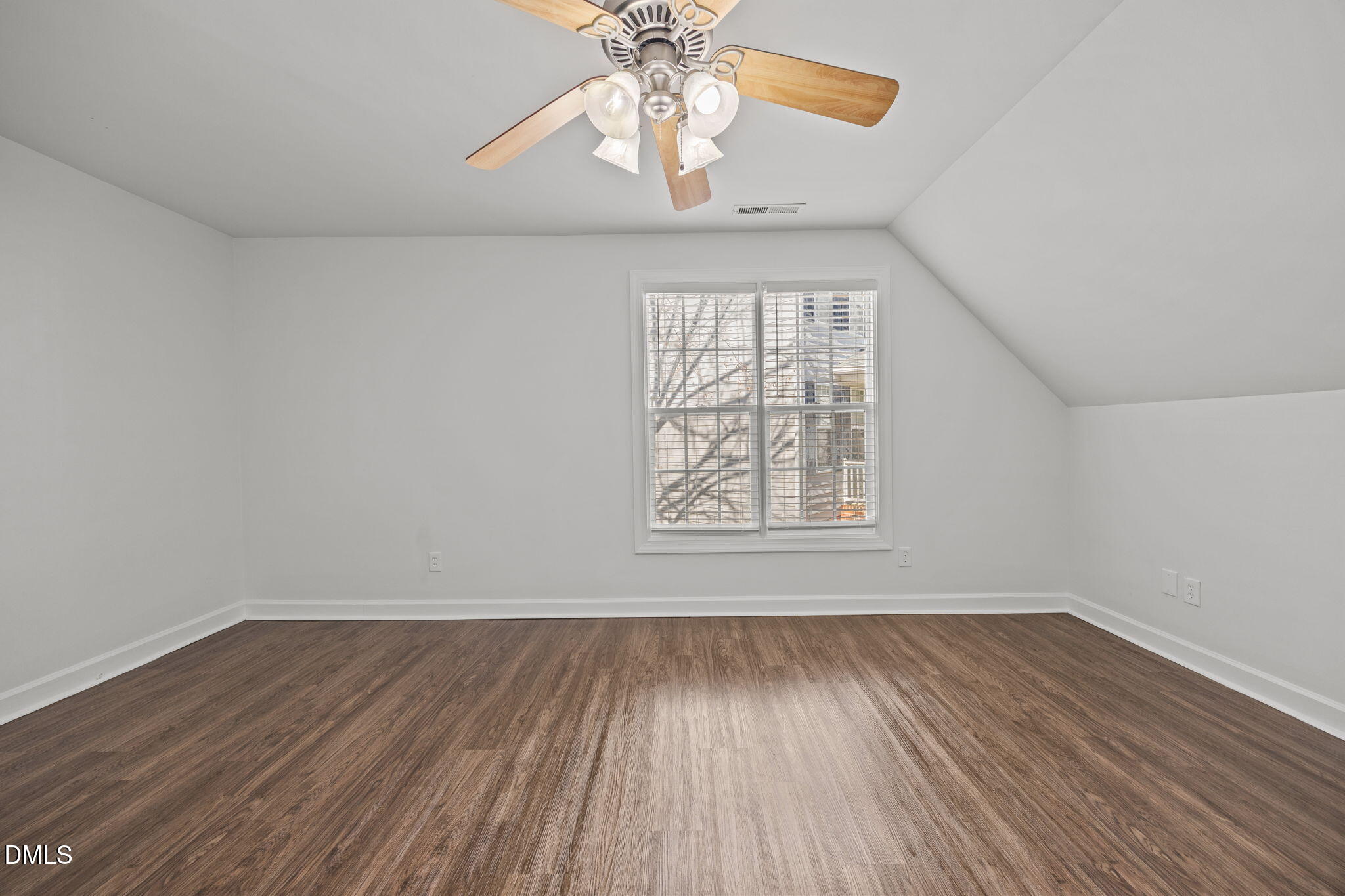 9220 Pennythorne Court Raleigh, NC 27615 - Photo 34 of 49 an empty room with wooden floor chandelier fan and windows