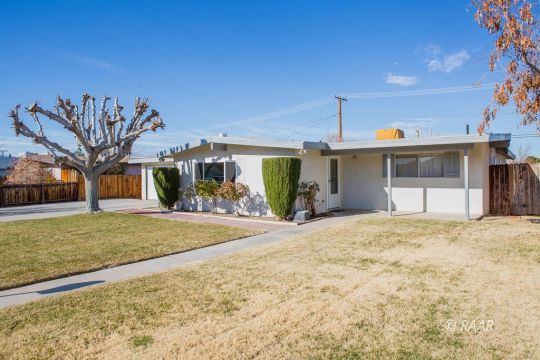 316 West Howell Avenue Ridgecrest, CA 93555 - Photo 3 of 31 a front view of a house with a yard and garage
