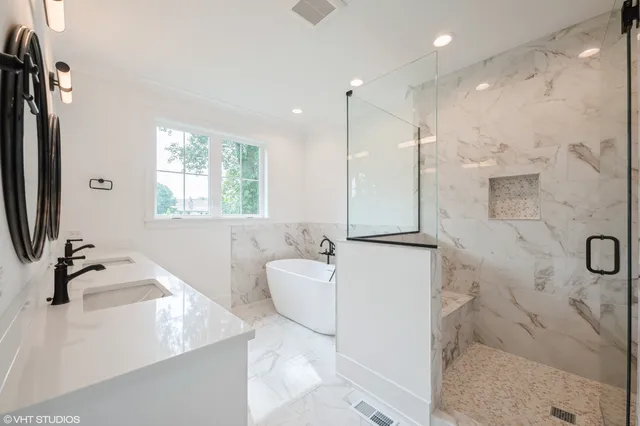 a bathroom with a double vanity sink a mirror and a shower