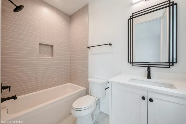 a bathroom with a toilet a sink and a bathtub