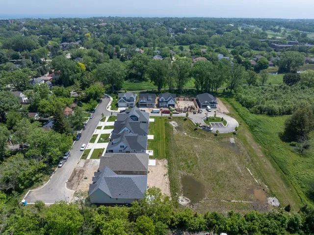 an aerial view of a house with yard swimming pool and lake view