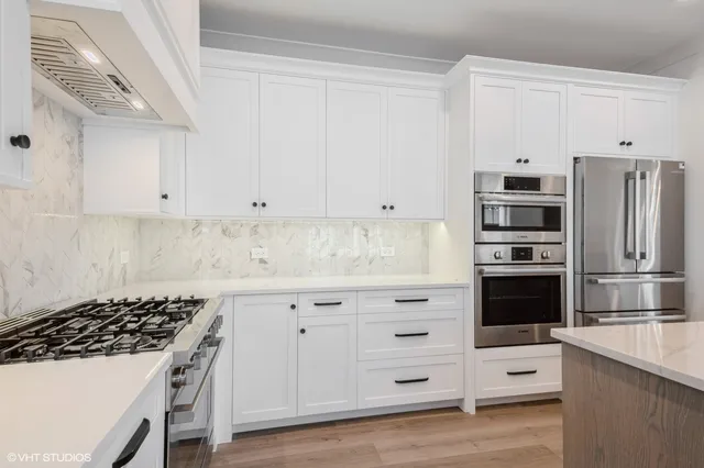 a kitchen with stainless steel appliances a stove and a refrigerator