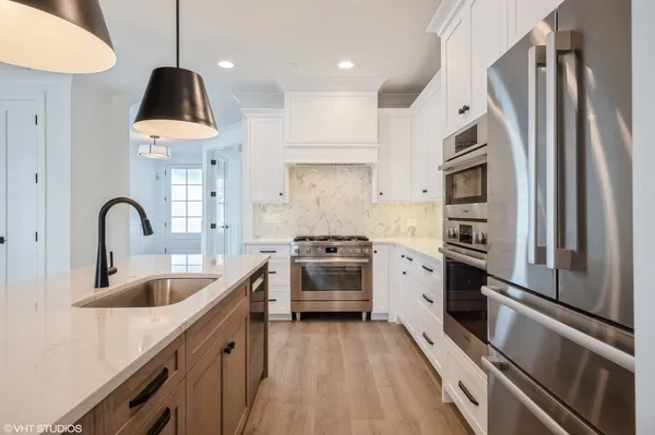 a kitchen with a sink stainless steel appliances and cabinets