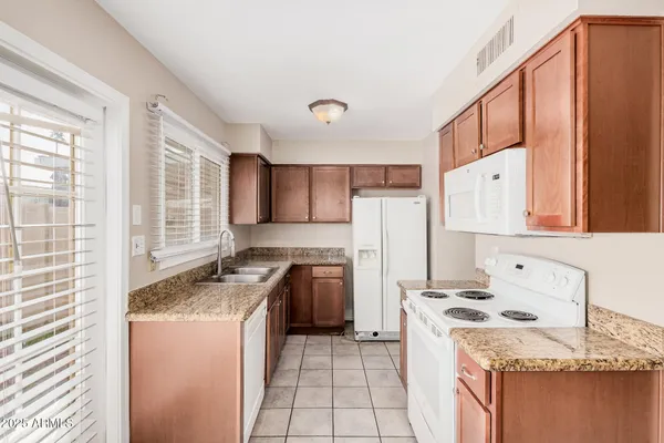 a kitchen with a stove a refrigerator and a sink