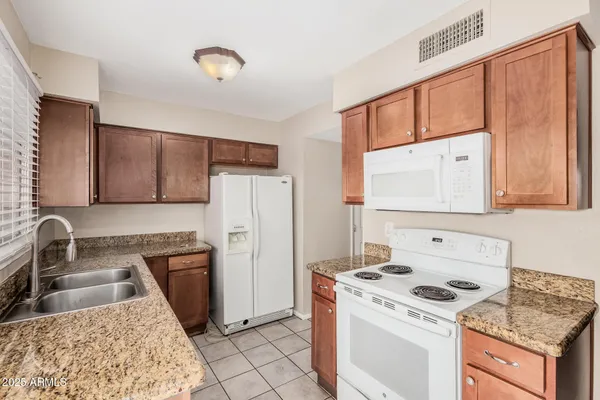 a kitchen with a stove a refrigerator and a sink